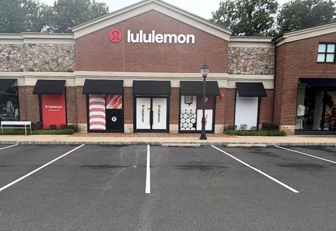 Lululemon storefront with black fabric awnings and illuminated channel letter sign